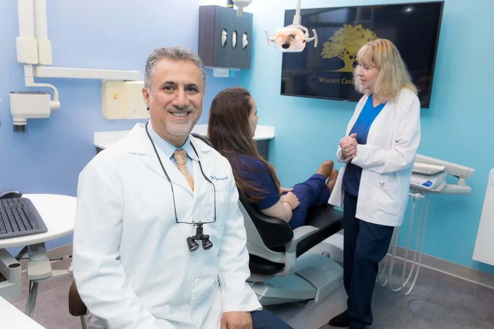 Dr. Darvish and the Walnut Creek Dental team with a patient in a treatment room